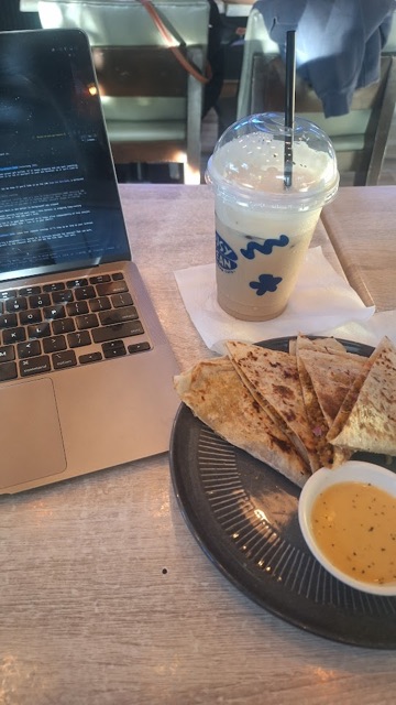 Laptop, iced drink, and quesadillas